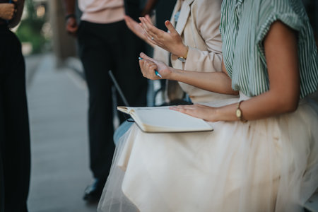 Casual group meeting with open notebook and hand gesturesの写真素材