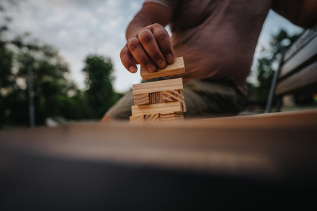 Father and son enjoying building blocks game in the parkの写真素材