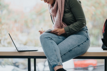 Young student studying with laptop in a casual settingの写真素材