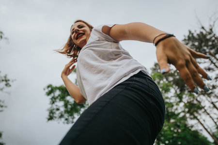 Joyful young woman enjoying a carefree day outdoors in natureの写真素材