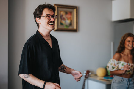 Friends laughing and enjoying a casual house gatheringの写真素材