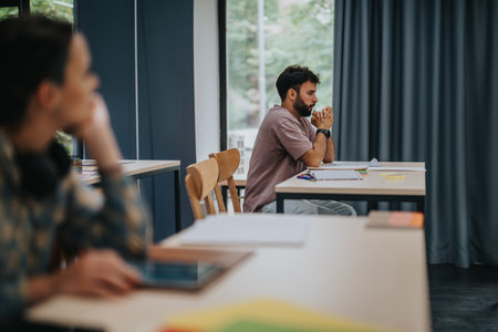 Stressed student preparing for an exam in a quiet classroomの写真素材