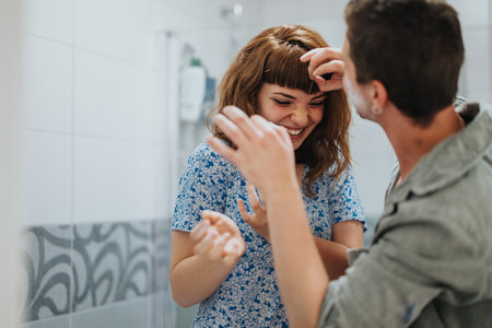 Happy couple getting ready for a fun night out togetherの写真素材