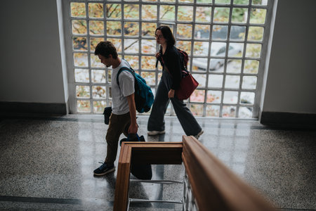 Students walking up staircase in a modern university buildingの写真素材