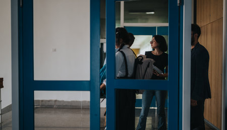 Group of students and professor outside classroom discussingの写真素材