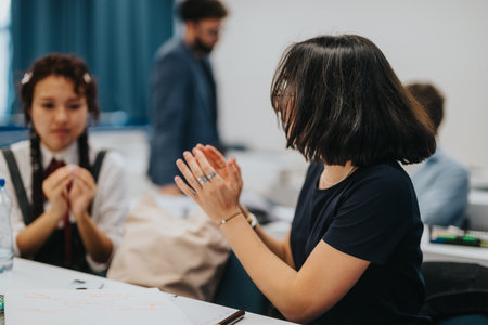 Students collaborating on tasks with guidance from a professorの写真素材