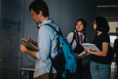 Students socializing in a school hallway between classesの写真素材