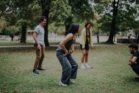 Students participating in outdoor sports class with instructor in parkの写真素材