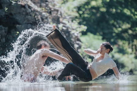 Joyful splash in the river with friends during summerの写真素材