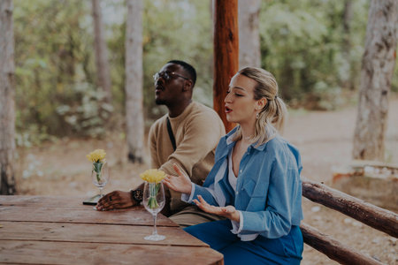 Two people having a meaningful conversation in a forest settingの写真素材