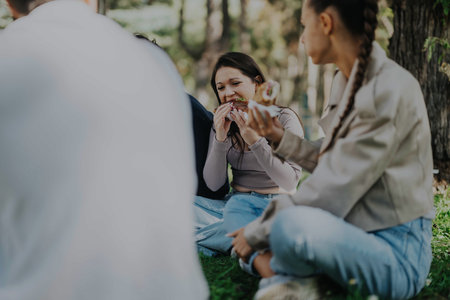 Young friends enjoying a picnic in a sunny park