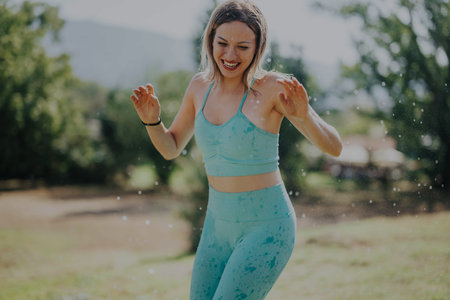 Joyful young woman enjoying outdoor exercise on a sunny day