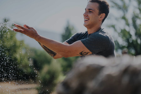 Young man enjoying an outdoor workout on a sunny dayの写真素材