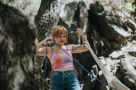 Woman enjoying outdoor adventure in natural forest settingの写真素材