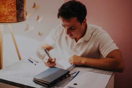College student studying at home with focused concentration
