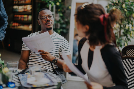 Diverse professionals collaborating on a project in a modern coffee shop
