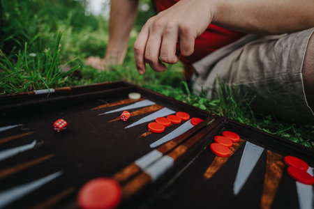 Outdoor backgammon game in progress with vibrant pieces on board