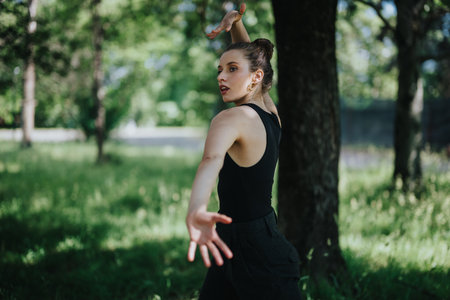 Lovely girl dancing in nature, female dancer performing modern dance in natureの写真素材