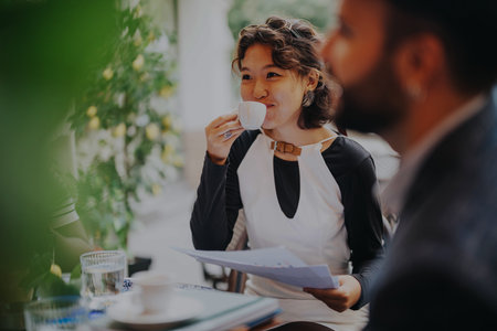 A multicultural group of professionals discussing project strategies in a contemporary coffee bar...