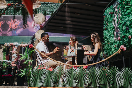 Multicultural businesspeople enjoying drinks and cheering for success at an outdoor cafe