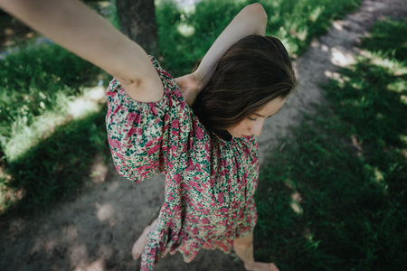 Girl performing expressive modern dance amidst natural surroundingsの写真素材