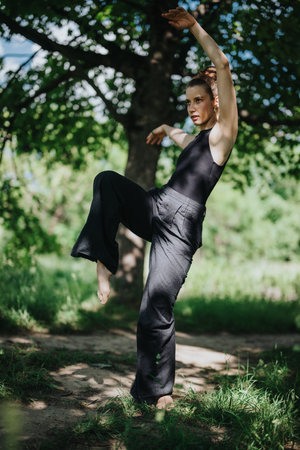 Young woman performing modern dance outdoors in natureの写真素材