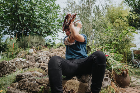 Young girl joyfully playing in a lush garden setting
