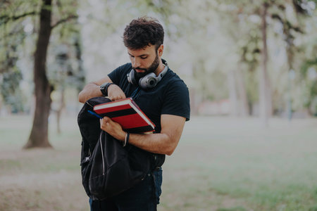 Student organizing school supplies outdoors in a park setting