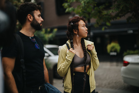 Young students walking outdoors on a casual urban dayの写真素材