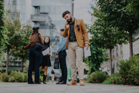 Business professionals engaged in outdoor project discussion and planningの写真素材