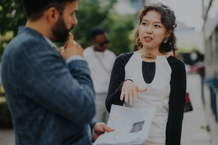 Professional business discussion outdoors in a casual settingの写真素材
