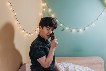 Young enjoying a moment with her pet parrot indoorsの写真素材