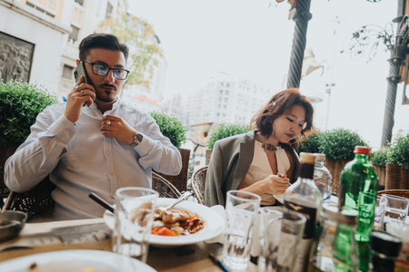 Business people having a casual outdoor meeting over lunch