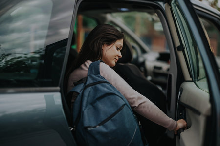 Parent drops off daughter at school with a blue backpack