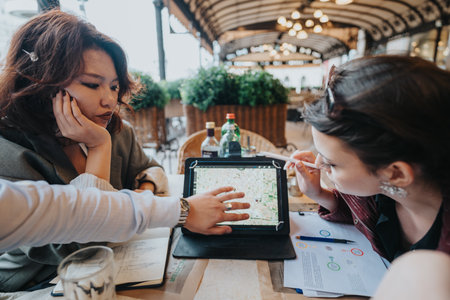 Business team discussing project ideas in outdoor cafe settingの写真素材