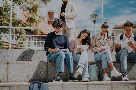 High school students learning outdoors with teachers guidanceの写真素材