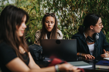 Group of students studying together at a coffee bar outdoors