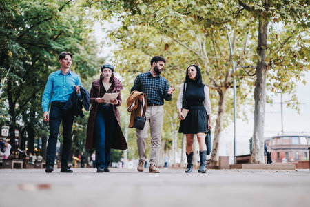 Group of young professionals walking and discussing ideas outdoorsの写真素材