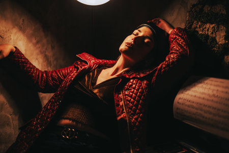 Dramatic portrait of a woman in red jacket under moody lighting