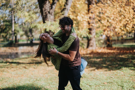 Young couple enjoying a playful moment in an autumn park