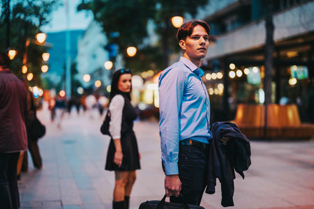 Business professionals in urban evening setting with street lightsの写真素材
