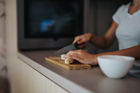Woman preparing fresh bread in a modern kitchen settingの写真素材