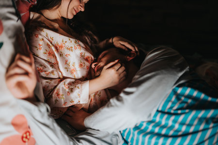 Couple embracing in bed with intimacy and affectionの写真素材