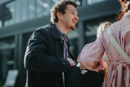 Young professionals engaging in lively outdoor conversationの写真素材