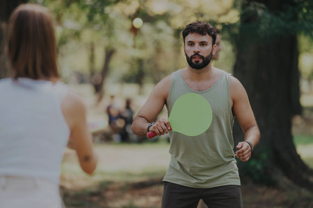 Friends playing a casual game of paddle tennis in the parkの写真素材