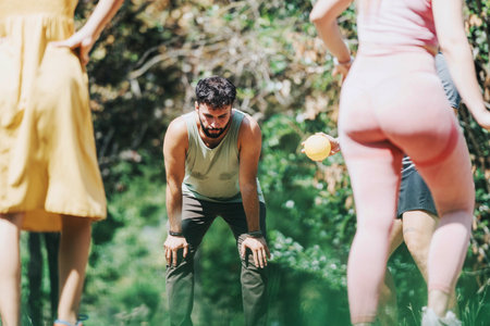 Group of friends enjoying a vigorous outdoor workout session in a sunny park environmentの写真素材