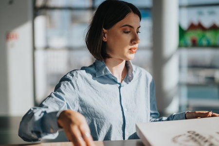 Focused professional woman strategizing project tasks in officeの写真素材