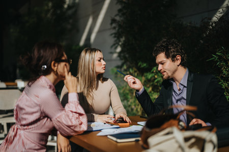 Multicultural business team having an outdoor meeting discussing ideasの写真素材