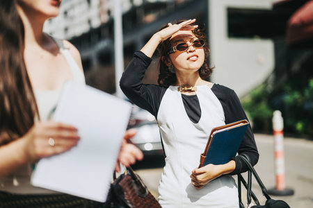 Business people discussing project outside on a sunny day