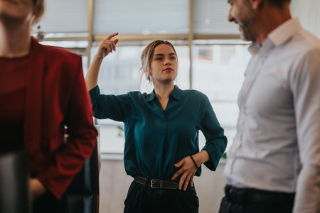 Confident woman leading a business discussion in officeの写真素材